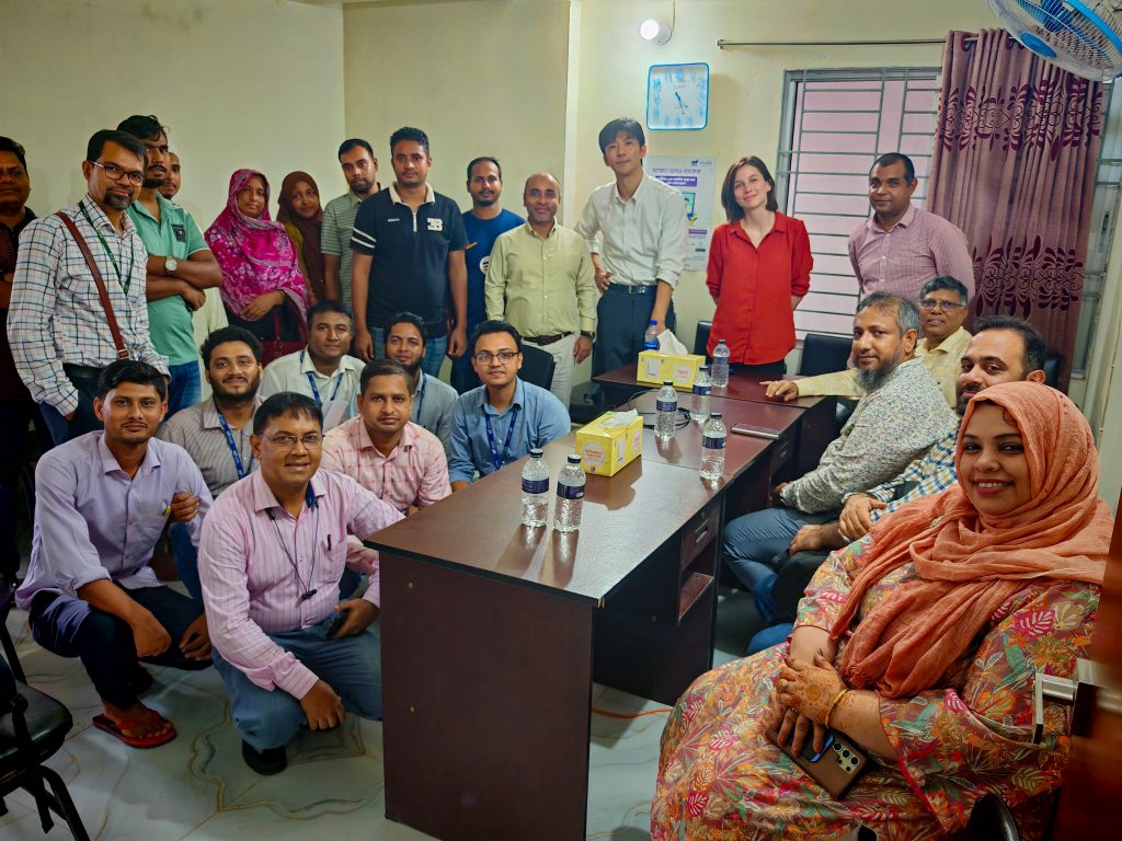 World Bank, PKSF and SAJIDA Foundation officials discuss RECP practices with an entrepreneur at a SMART-supported food business.