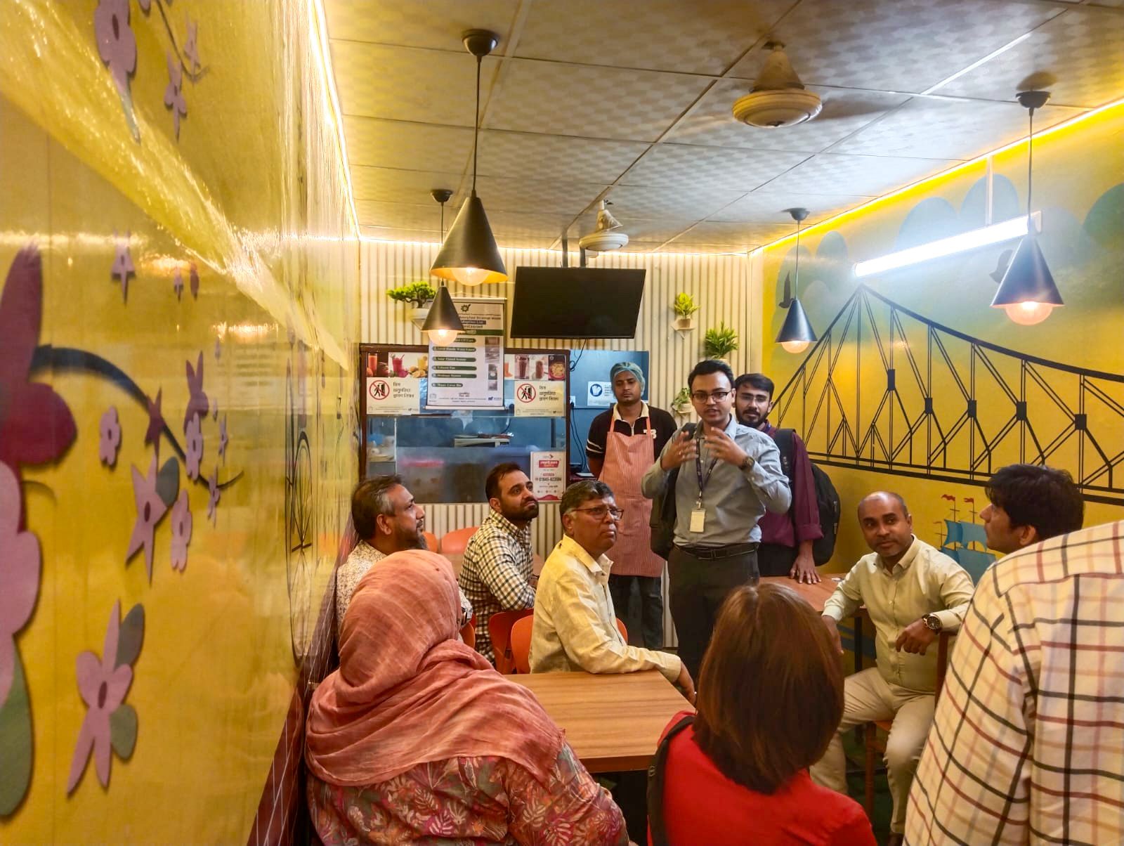 World Bank and PKSF delegation members visit a SMART-supported food business in Badda, Dhaka.