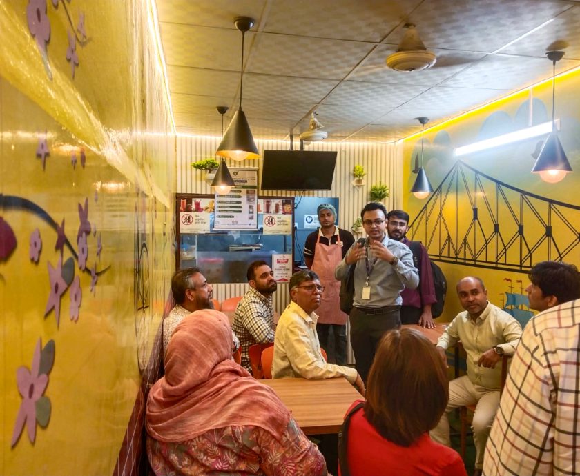 World Bank and PKSF delegation members visit a SMART-supported food business in Badda, Dhaka.